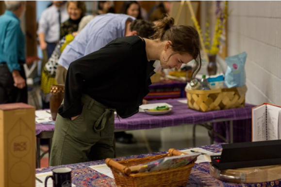 Ali Zeurcher looks over a silent auction table